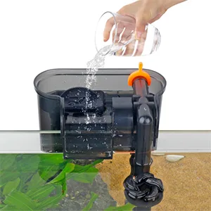 Hand pouring water into a hygger aquarium filter system with green plants visible below