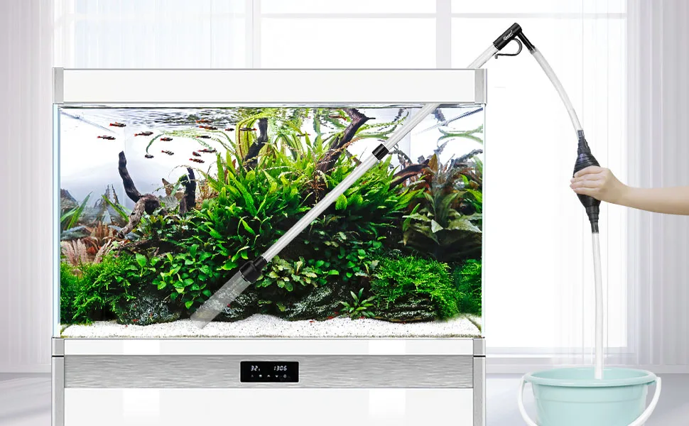 A modern hygger aquarium with lush green plants, fish, and a cleaning tool being used. Features a digital display and a bucke