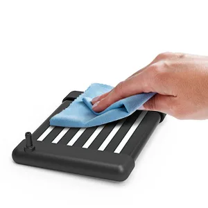 Hand using blue cloth to clean aquarium filter with black base and white slats