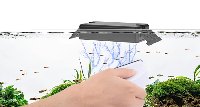 Hand holding smartphone controlling smart aquarium filter with fish and plants underwater