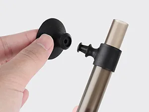 Hand holding black silicone cap next to aquarium air pump with adjustable valve