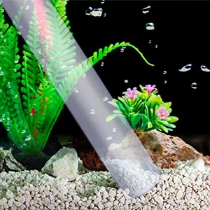 Hygger aquarium with clear tube, green plants, pink flowers, and gravel substrate