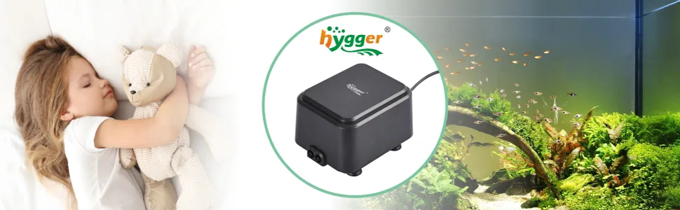 A child sleeps with a teddy bear while a hygger aquarium pump circulates water in a lush, fish-filled tank.