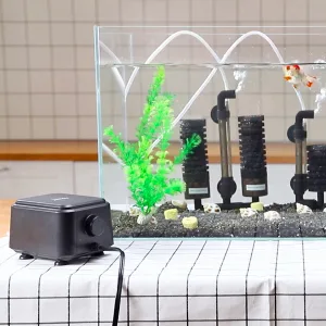 Hygger aquarium with LED lights, artificial plants, and decorative rocks for a modern fish tank setup.