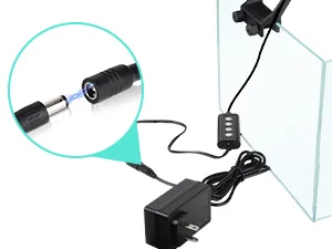 Close-up of hygger aquarium LED light connector with power adapter and control unit attached to glass tank