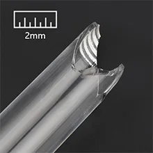 Close-up of a transparent aquarium tube with a 2mm scale marker showing its thin wall and precise measurement for aquarium eq