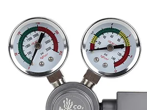 Dual CO2 regulator gauge set for aquariums, showing pressure readings with red, green, and yellow zones.