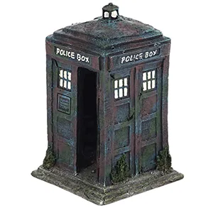 A miniature model of a classic British police box, featuring 'POLICE BOX' signage and detailed windows, displayed on a stone