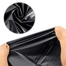 Black waterproof pond liner being held by hands with close-up texture detail