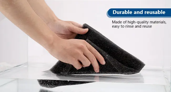 A person using a black hygger aquarium cleaning sponge on a glass surface, labeled 'Durable and reusable' with text about hig
